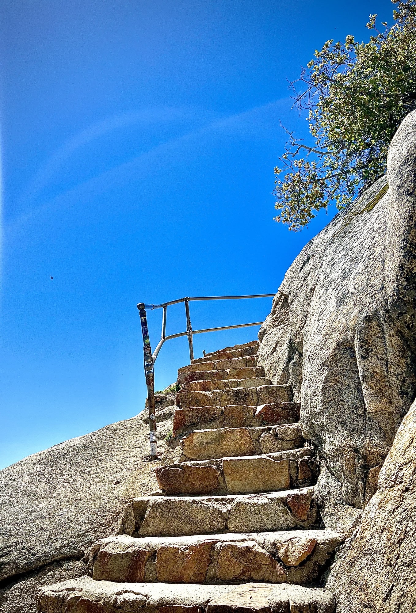 Stone steps carved into a granite outcrop, leading toward the sky